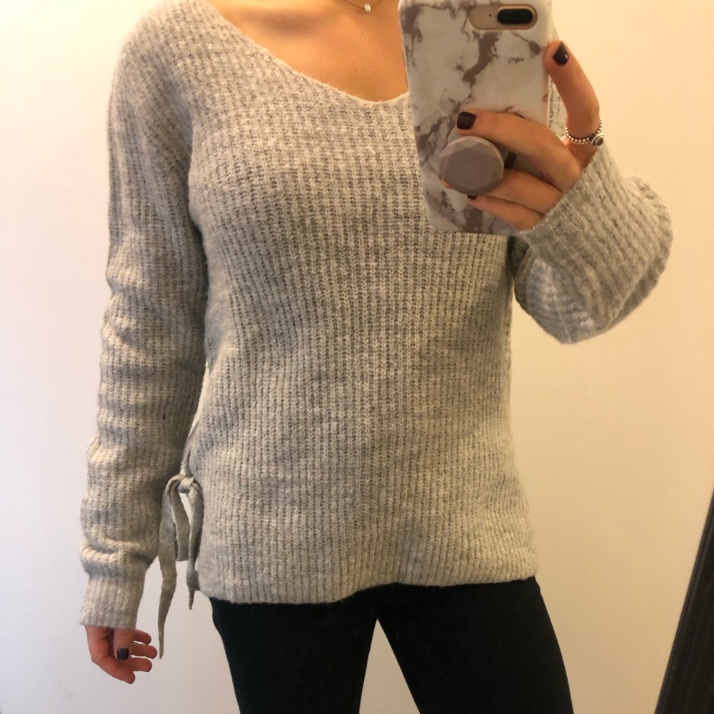 Gray sweater with ties along the sides